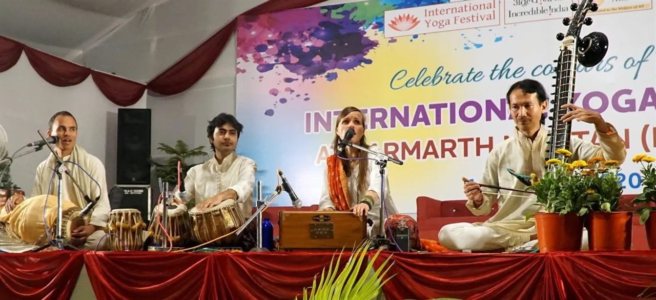 Live kirtan ensemble performing at a yoga festival