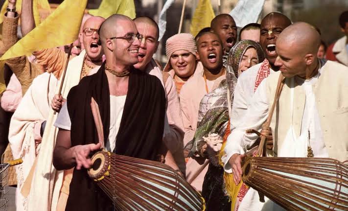 Devotees gathered chanting with mridanga drums